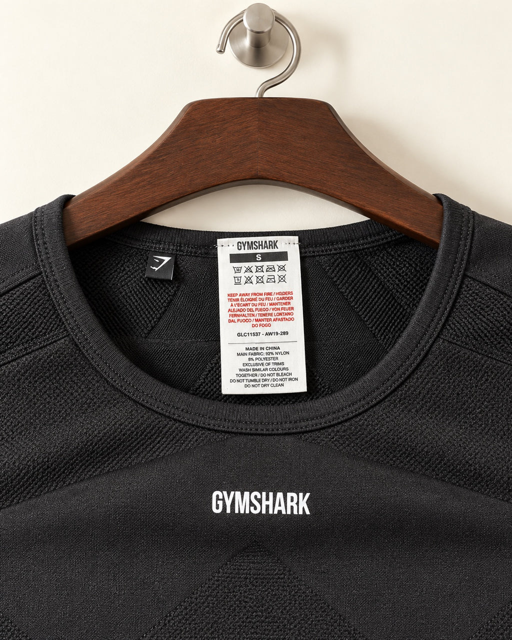 Gymshark cropped training top neck label showing size S
