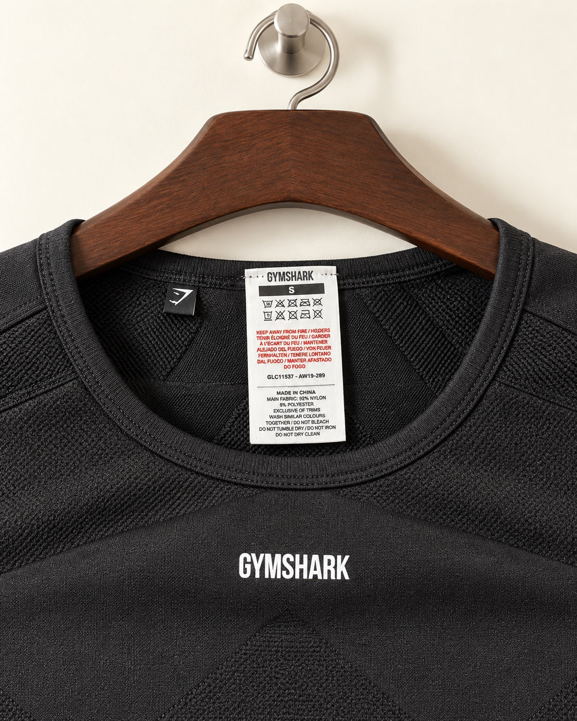 Gymshark cropped training top neck label showing size S