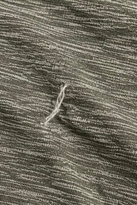 Close-up of loose thread/snag on lululemon grey space-dye T-shirt