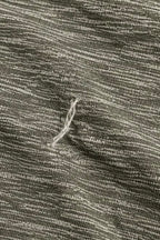 Close-up of loose thread/snag on lululemon grey space-dye T-shirt