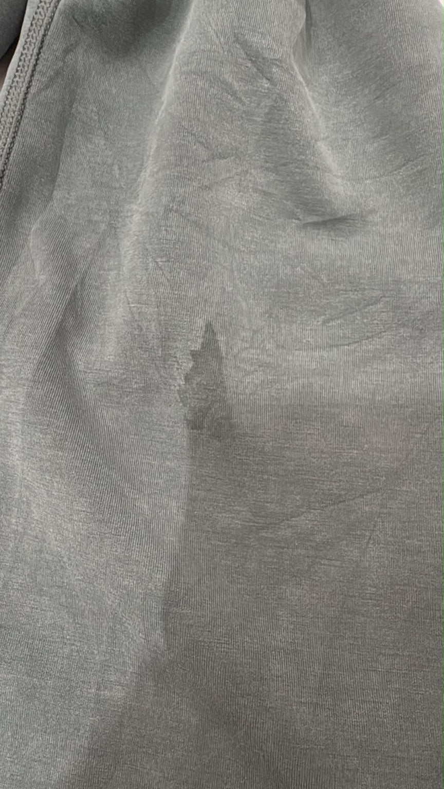 Close-up of visible darker mark on lululemon sage green trouser leg