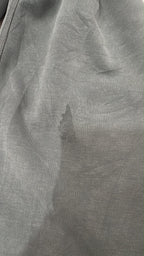 Close-up of visible darker mark on lululemon sage green trouser leg